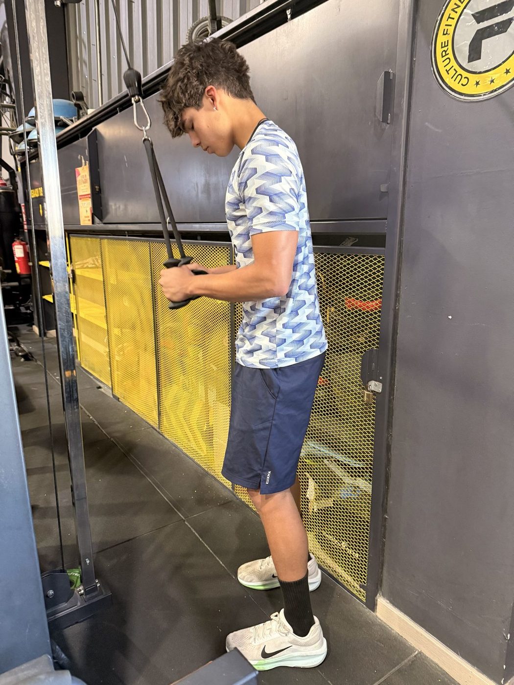 Josh doing a rope pushdown on a cable machine.