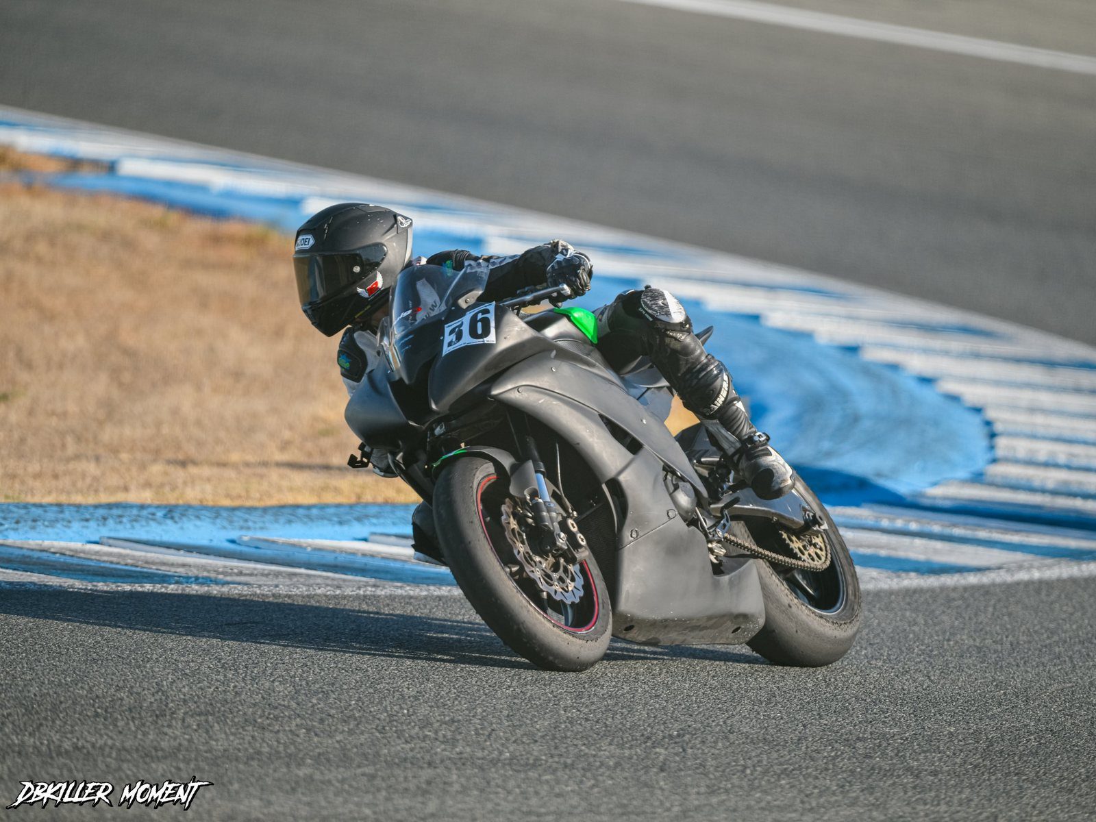 Josh in black leathers and helmet leaning into a corner on his black R6, number 36 on the fairing.