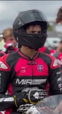 Josh in his pink and black MIR Racing leathers and black helmet.
